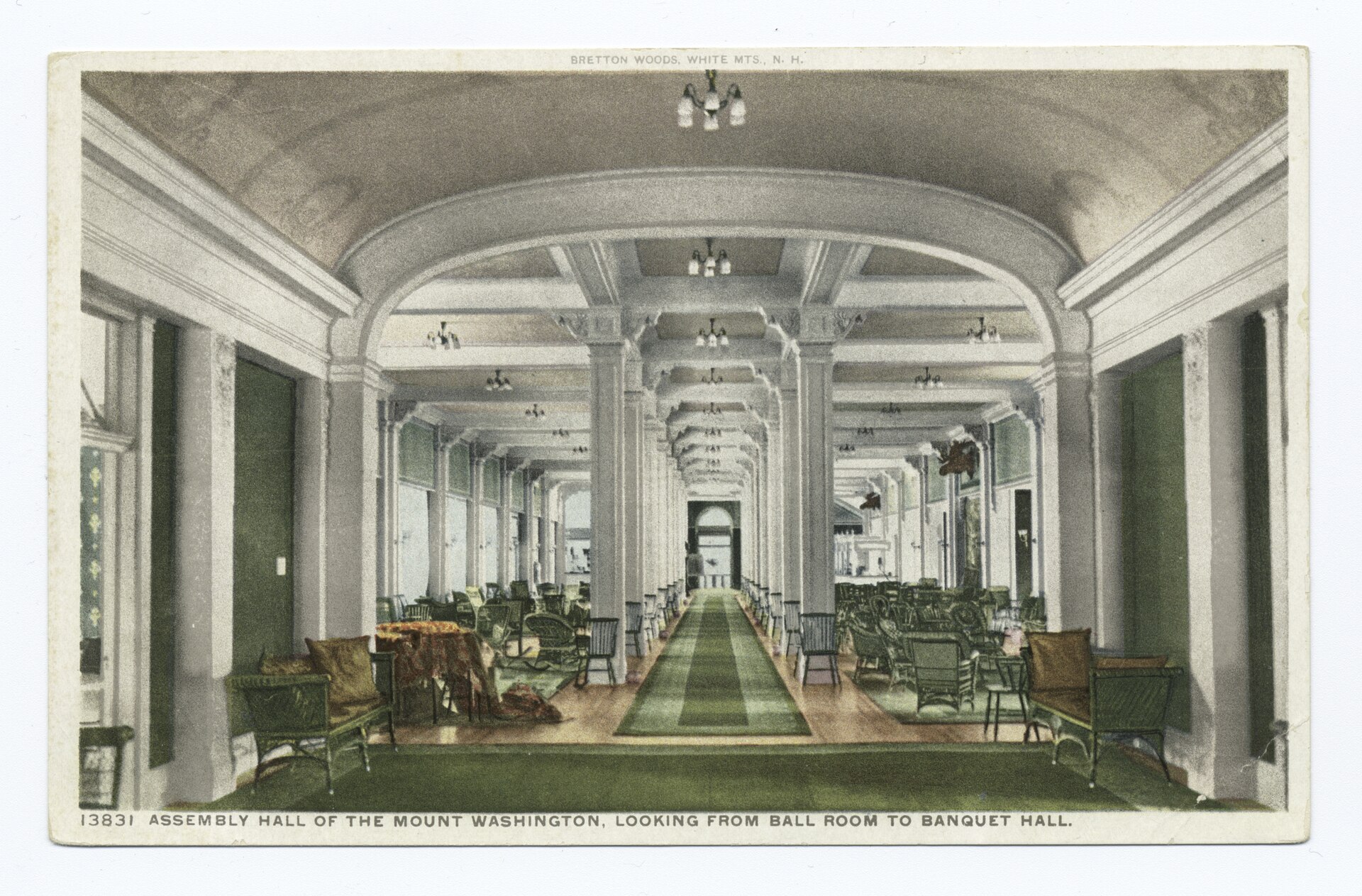 A long hall with columns, chandeliers and wicker chairs, in a hand-colored postcard