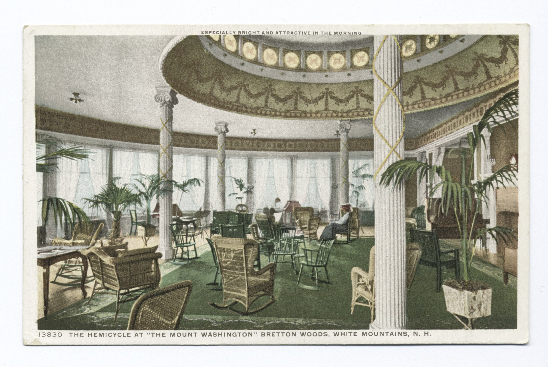 A curved room with a domed ceiling, columns, palms and wicker furniture, in a hand-colored postcard