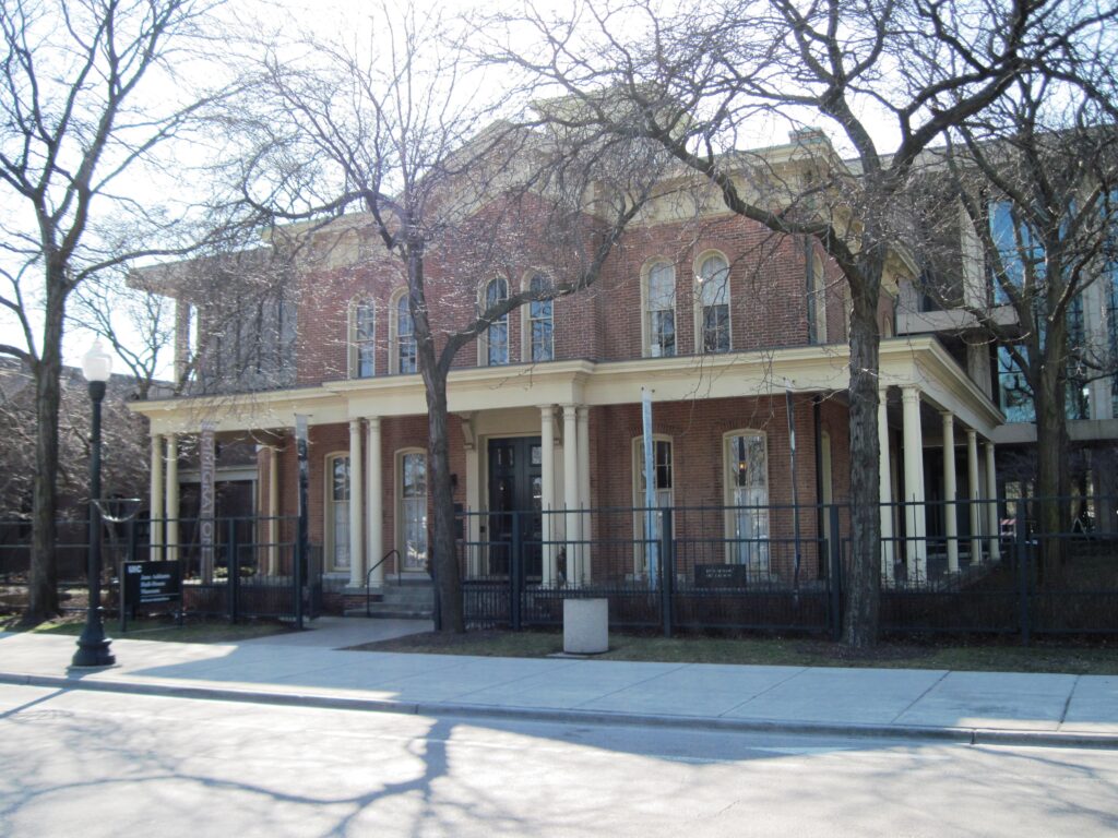 The 1856 Hull mansion's brick front and columned porch on Halsted Street