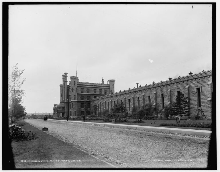 The Illinois State Penitentiary at Joliet around 1900, with its castle-like towers and long stone cell-house wall