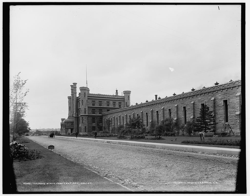 The Illinois State Penitentiary at Joliet around 1900, with its castle-like towers and long stone cell-house wall