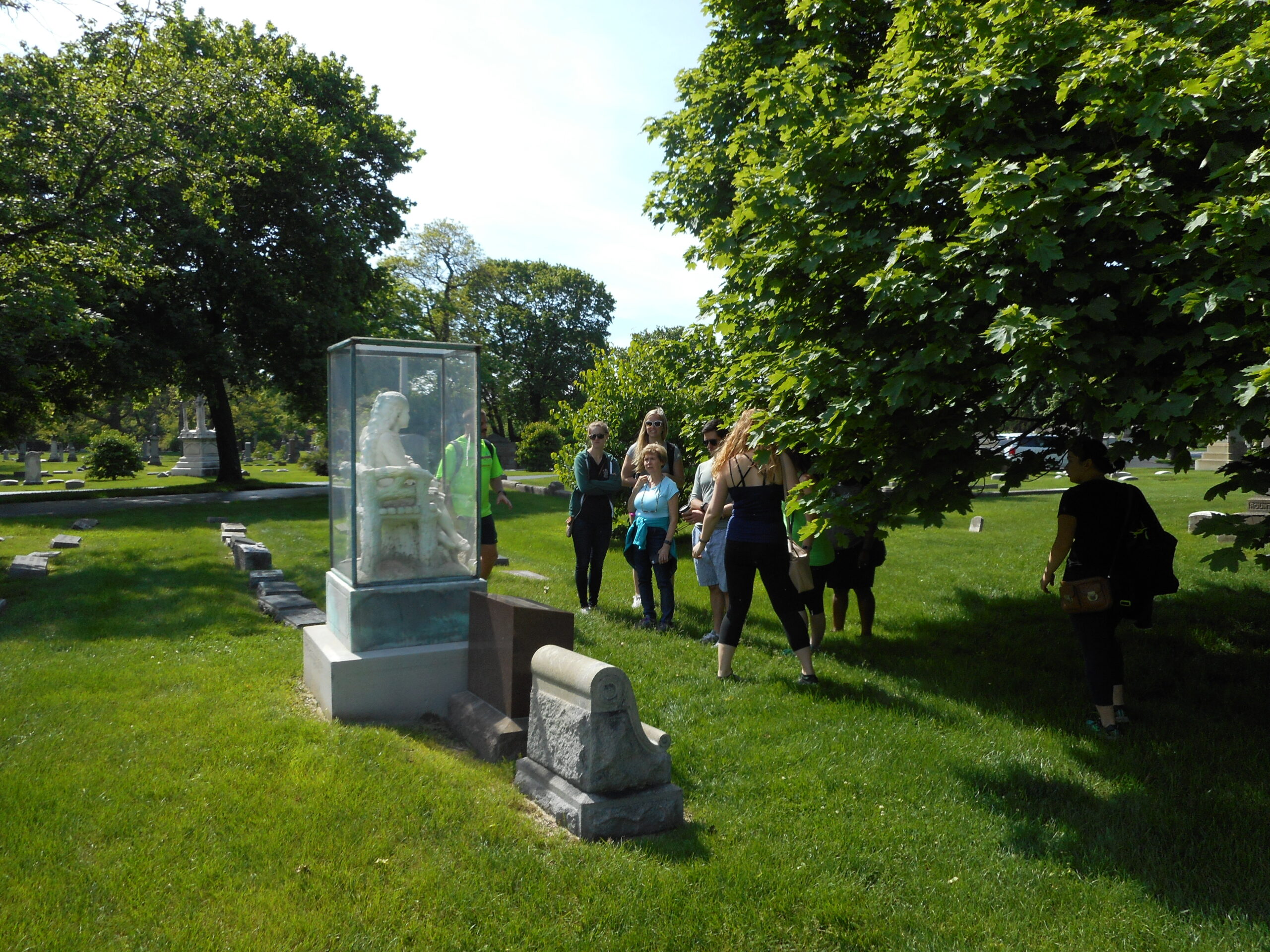 The statue of Inez Clarke in its glass case at Graceland Cemetery