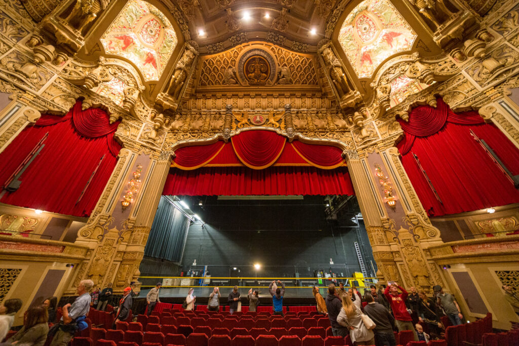 The gilded auditorium of today's Nederlander Theatre, with red curtains framing the stage