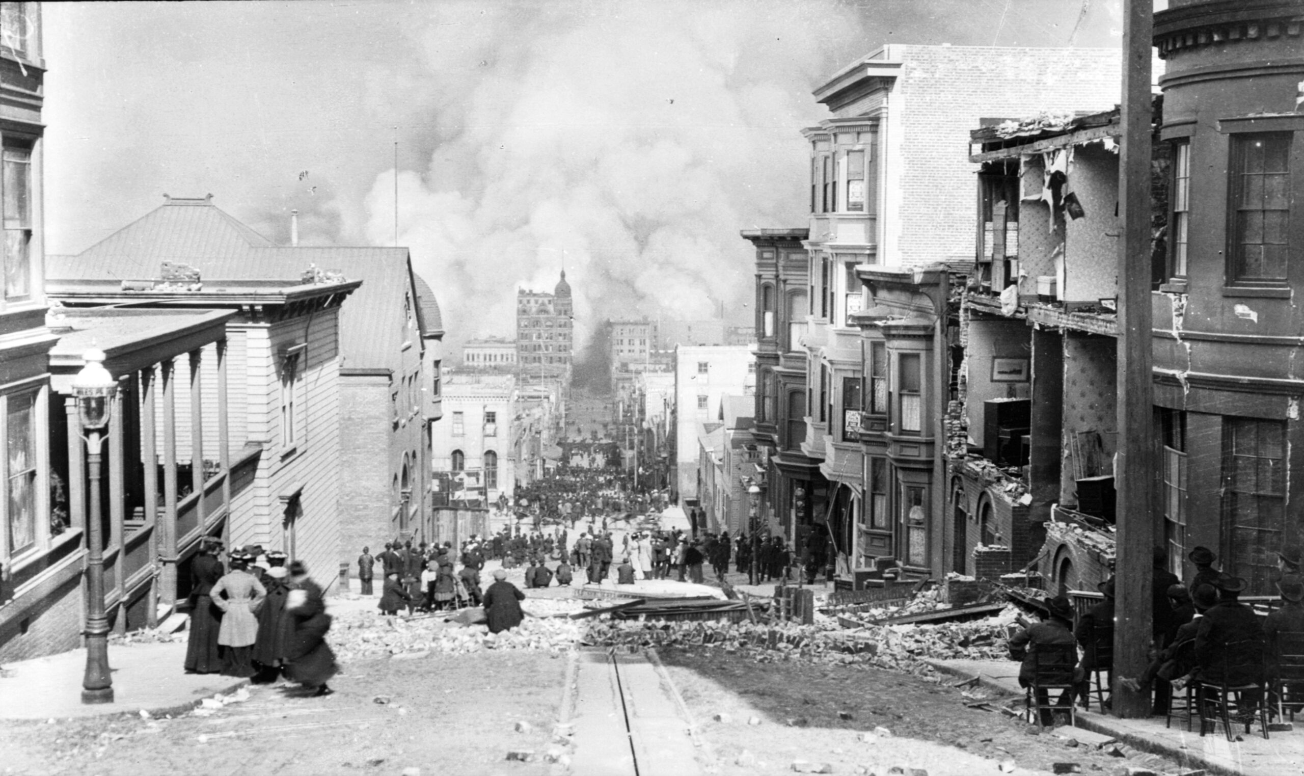 People standing in Sacramento Street watching smoke from the fire rise over downtown San Francisco on April 18, 1906