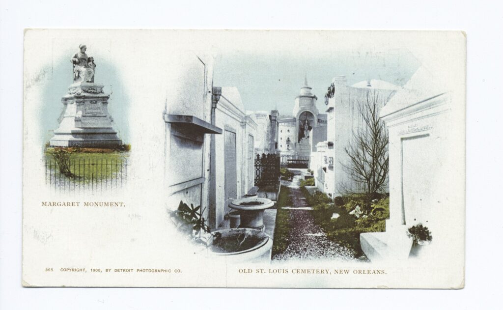 A postcard with a statue of a seated woman on the left and white tombs along a narrow path on the right