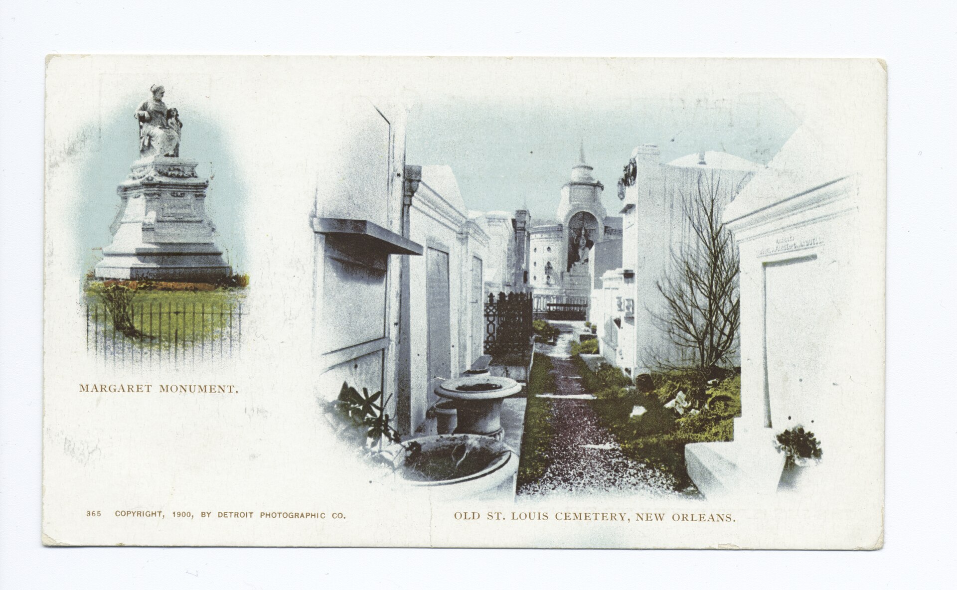 A postcard with a statue of a seated woman on the left and white tombs along a narrow path on the right