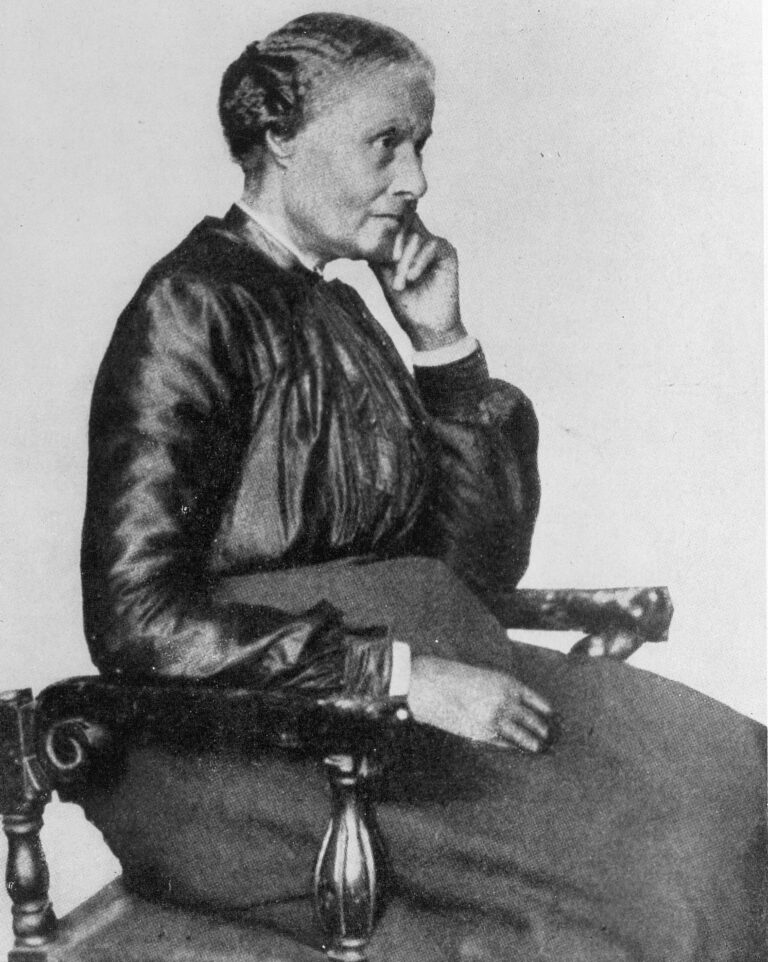 A 1901 studio portrait of Mary Ellen Pleasant seated in a chair, her chin resting on her hand