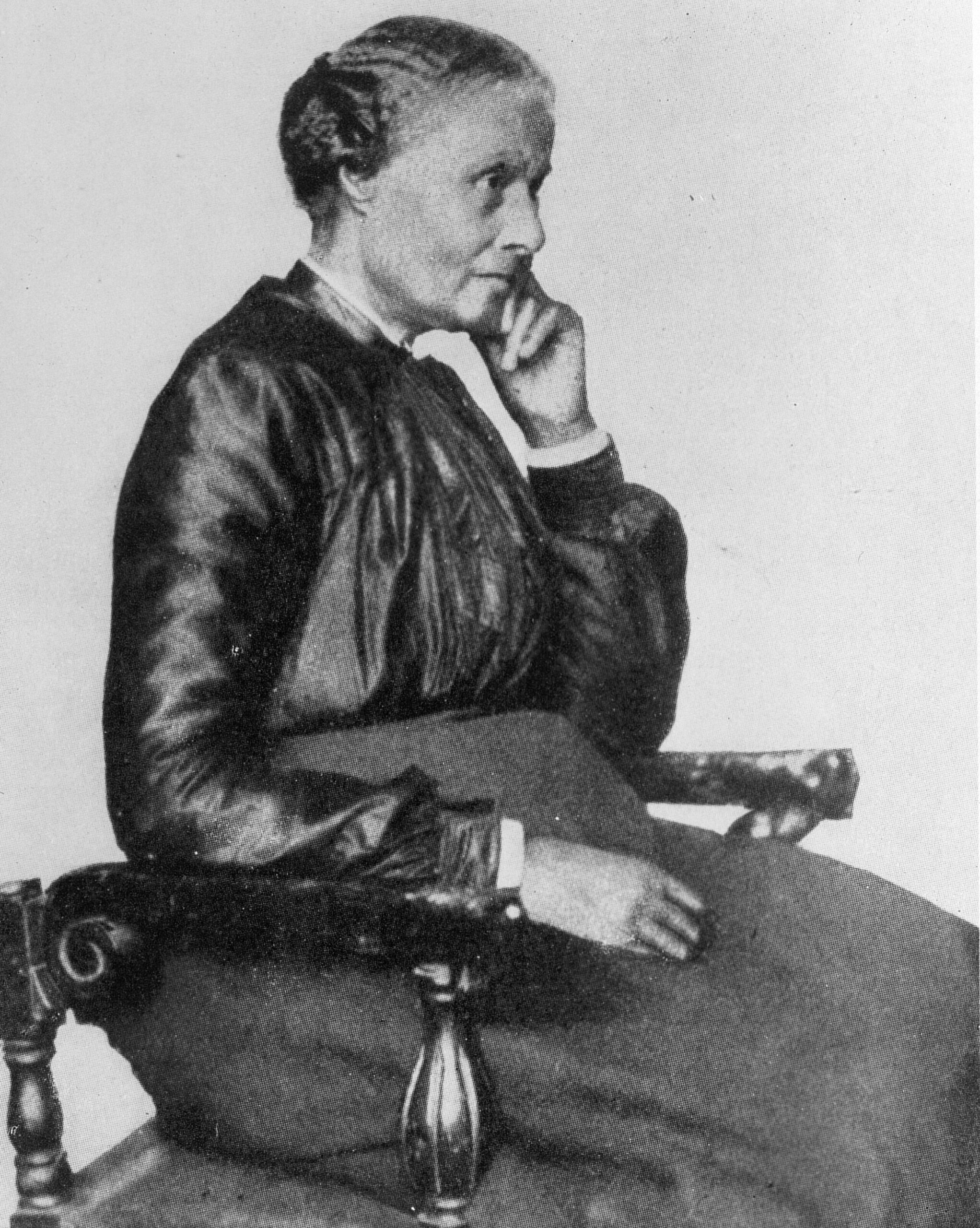A 1901 studio portrait of Mary Ellen Pleasant seated in a chair, her chin resting on her hand