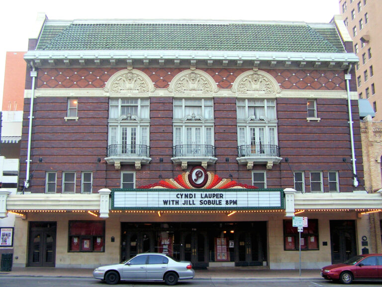 The brick and terra-cotta front of the Paramount Theatre in Austin, with its lit marquee over the sidewalk