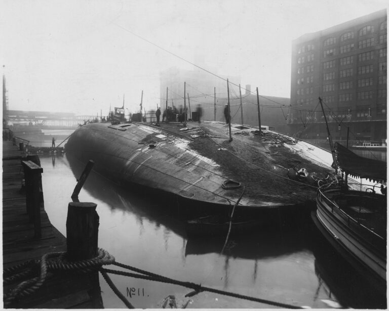 The Eastland lying on its side in the Chicago River in July 1915, beside the wharf