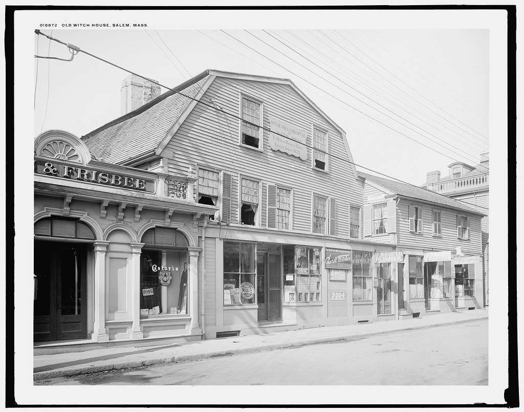 A 1906 photograph of the Witch House with a two-story commercial storefront built across its street side