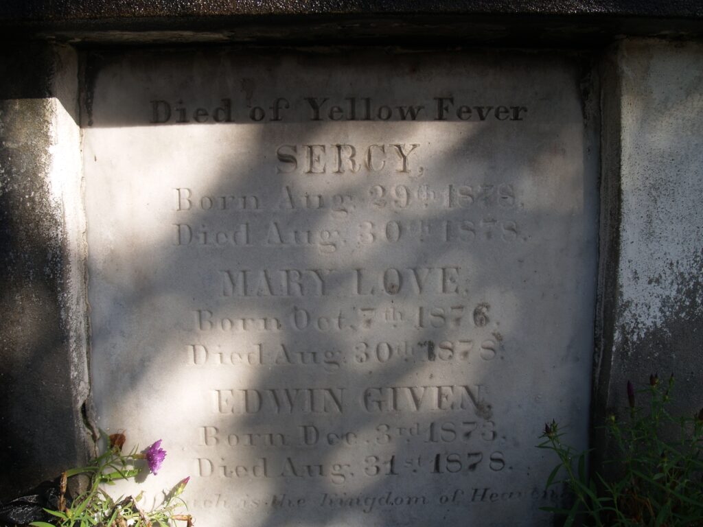 A marble tablet headed Died of Yellow Fever, listing three names with their birth and death dates